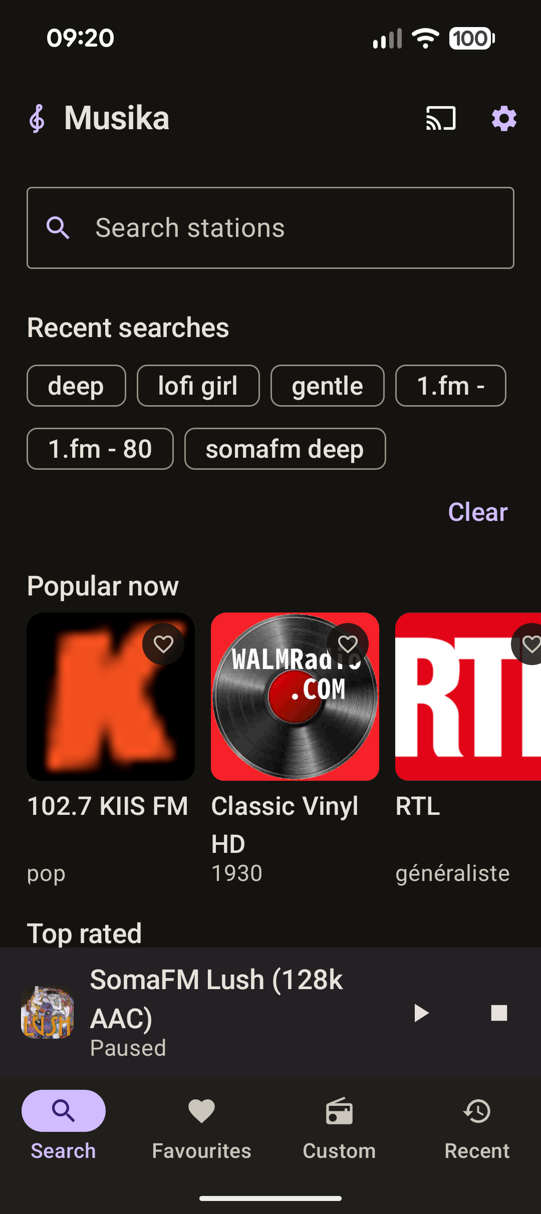 The Musika Search tab, showing a search box above recent search chips
                and rows of station artwork under Popular now and Top rated.
